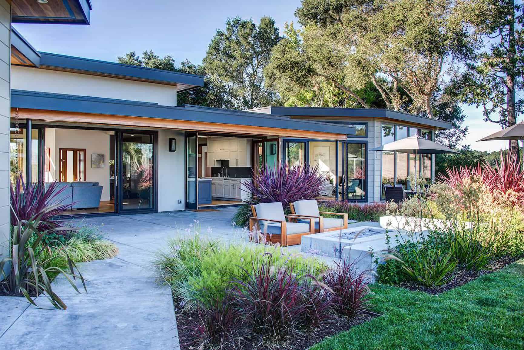 Beautiful California landscaping surrounds modern home.