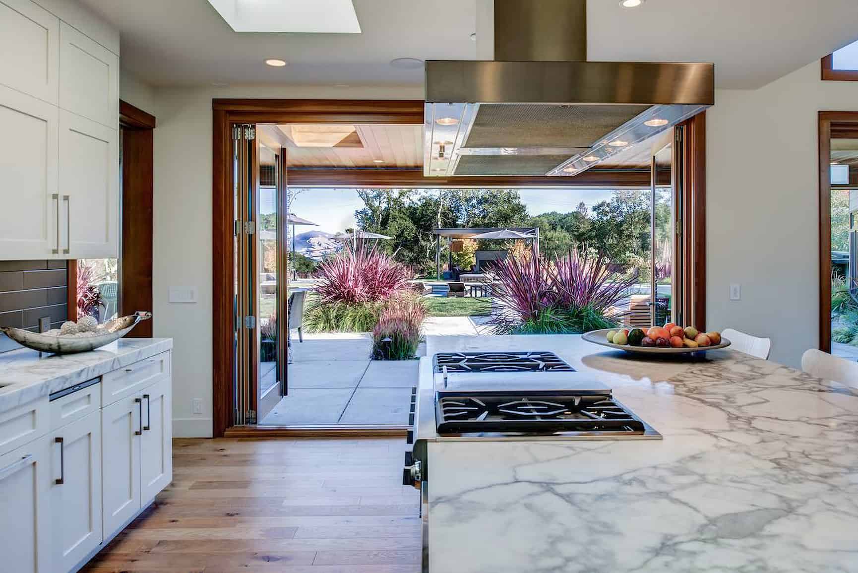 Close-up of modern kitchen countertop with views to the outdoors.