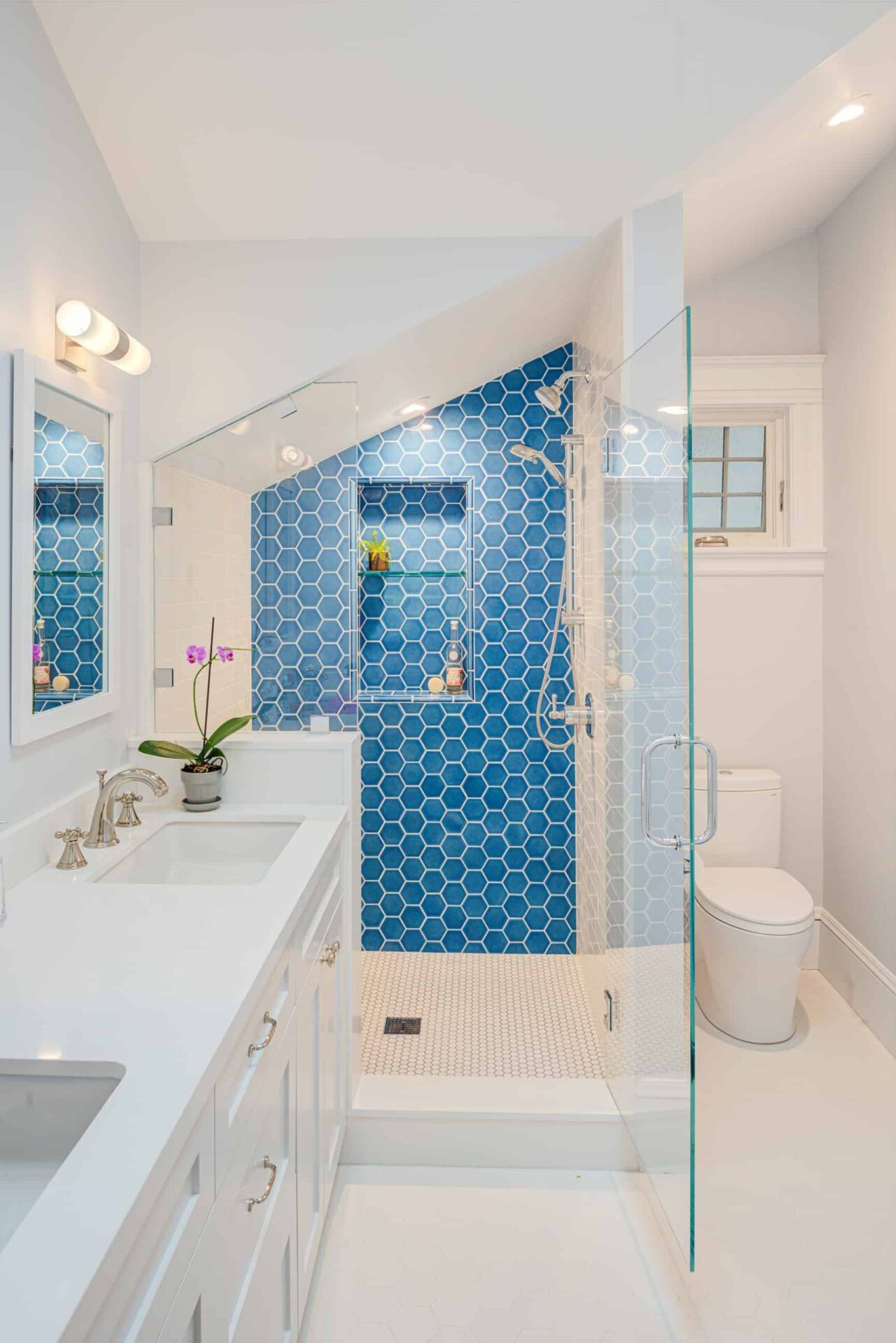 Modern, remodeled bathroom with stunning blue tile.