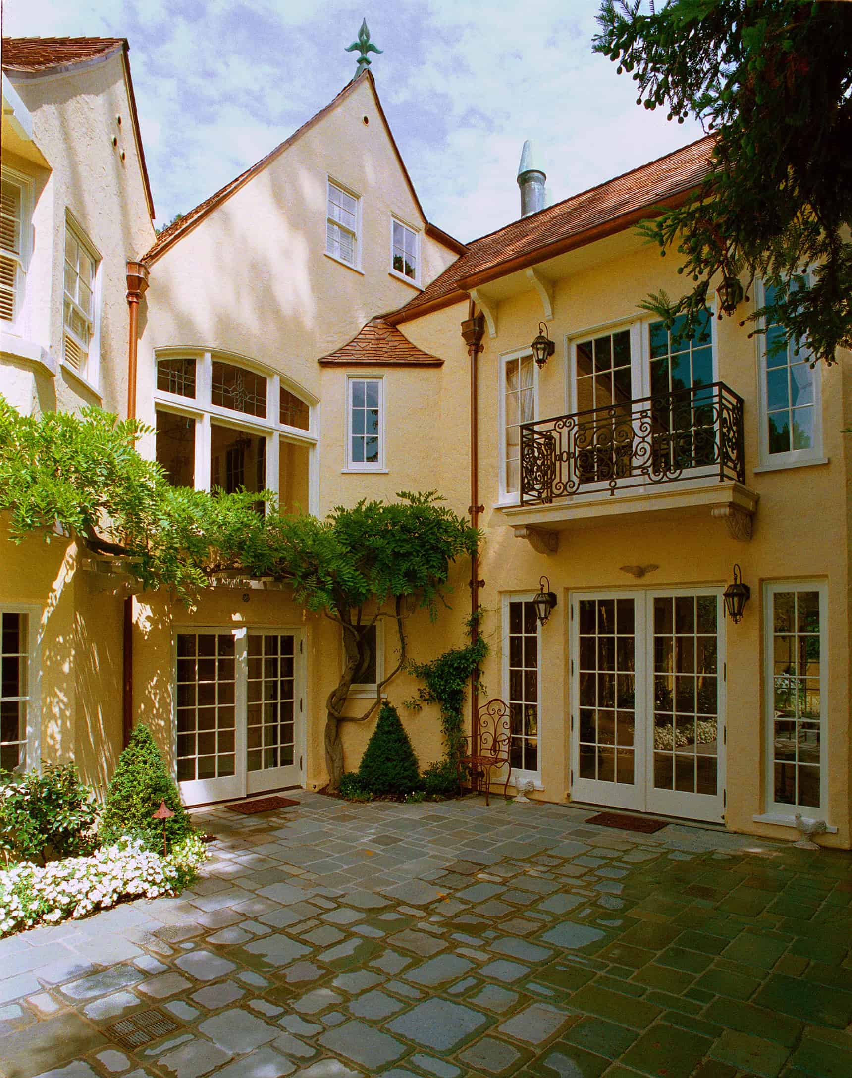 Exterior view of historic home with cobblestone entryway.