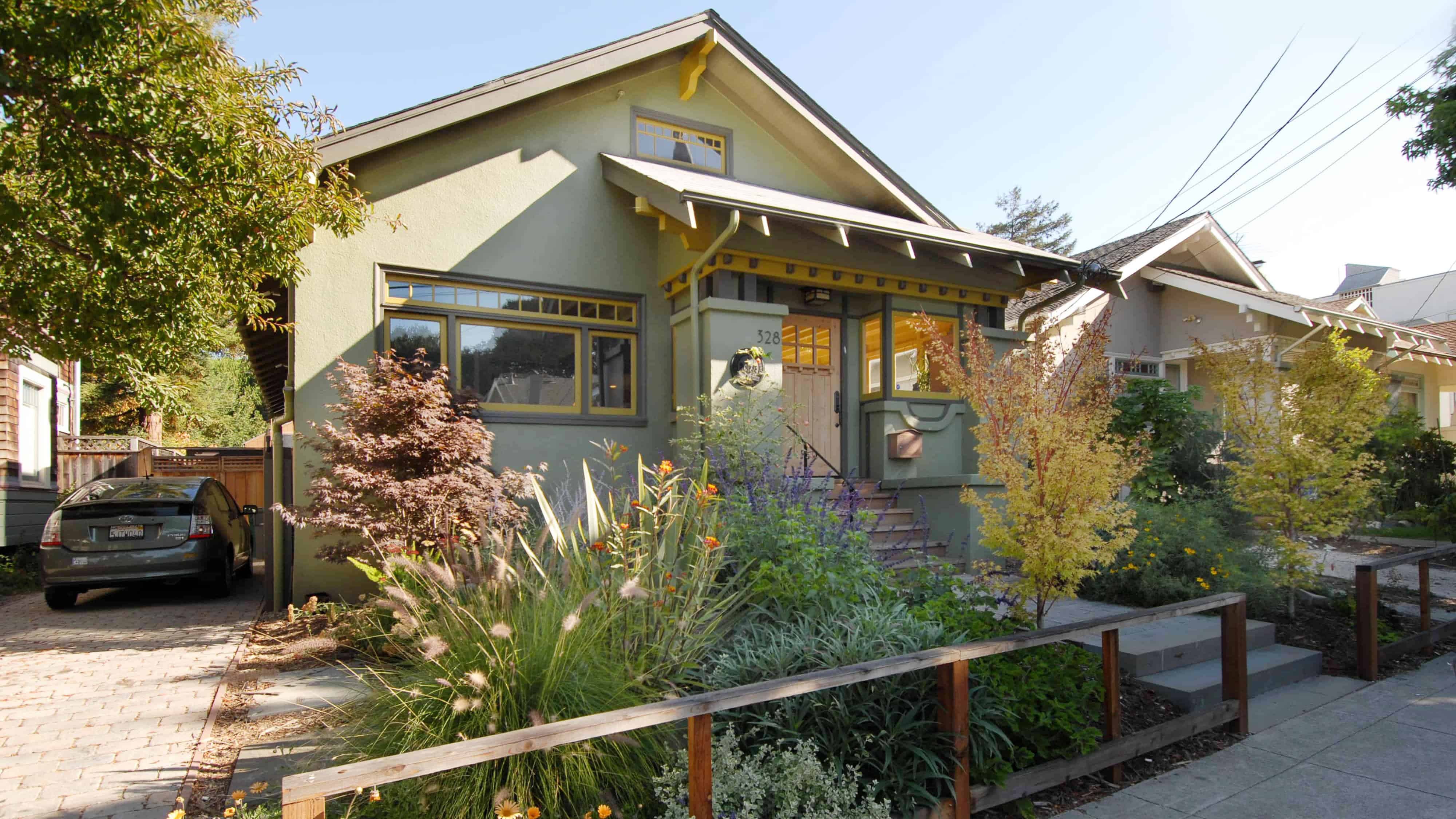 Exterior view of craftsman home with colorful landscaping.