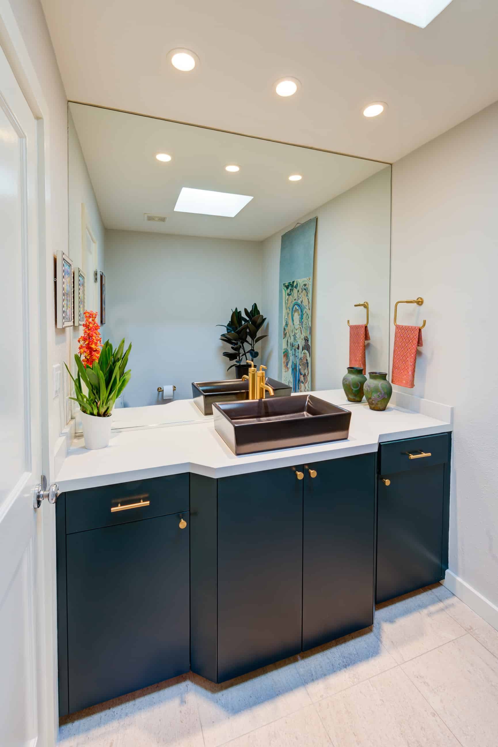 Recent bathroom renovation featuring blue modern cabinets.