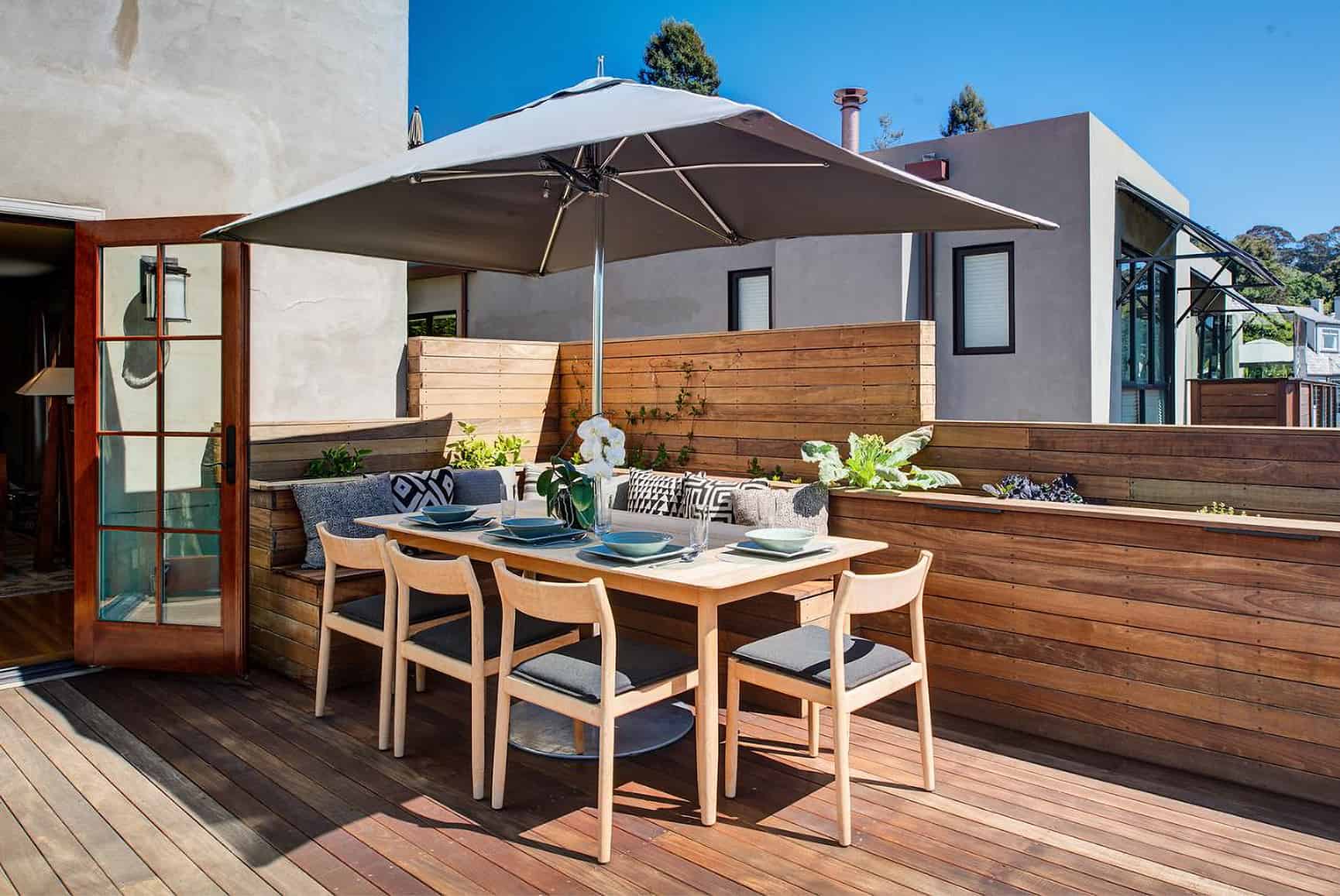 Outdoor dining area with an umbrella for shade.