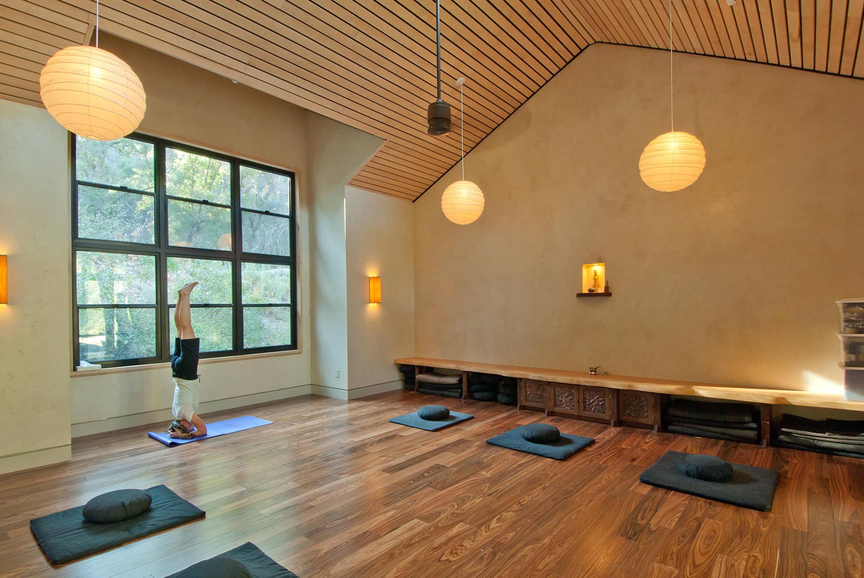 Interior view of newly constructed building used as a yoga retreat with light streaming in.