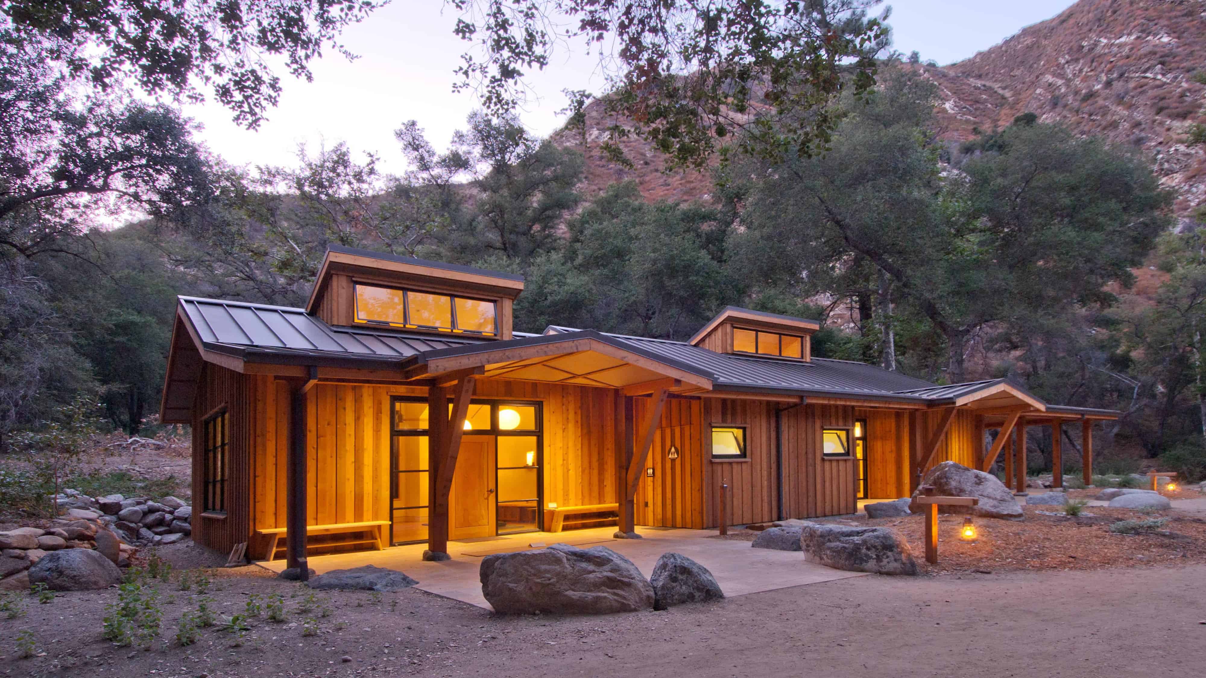 Exterior view of newly constructed building used as a yoga retreat nestled in the woods.