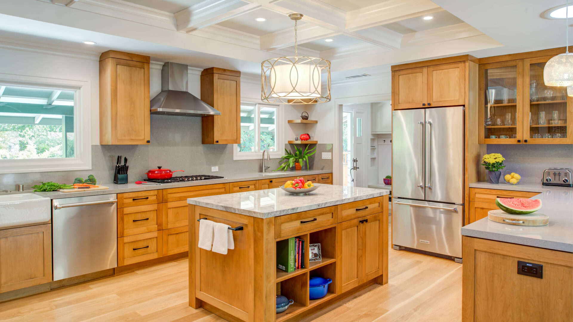 Warm inviting kitchen with farm style sink, alder wood cabinets, white oak hardwood floors. 