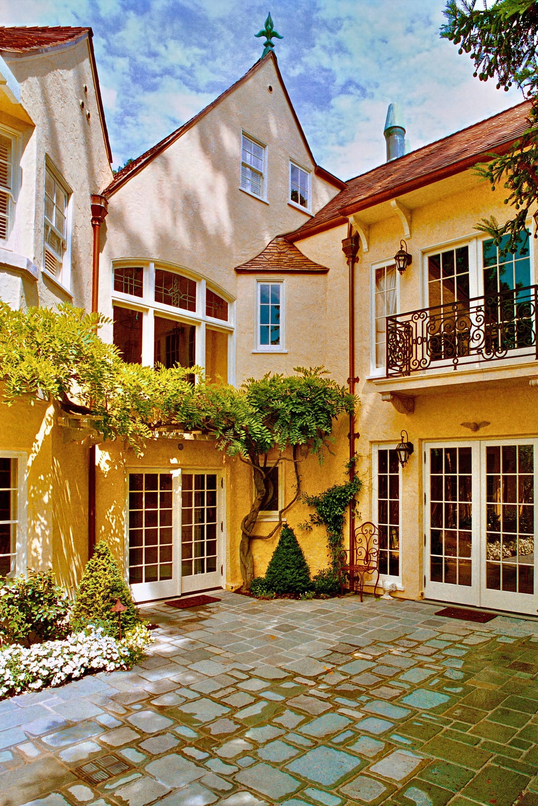historic storybook-style home originally designed by architect William Yelland, showing restored structural elements and preserved architectural details after a full renovation that blends modern upgrades with the home’s original character.