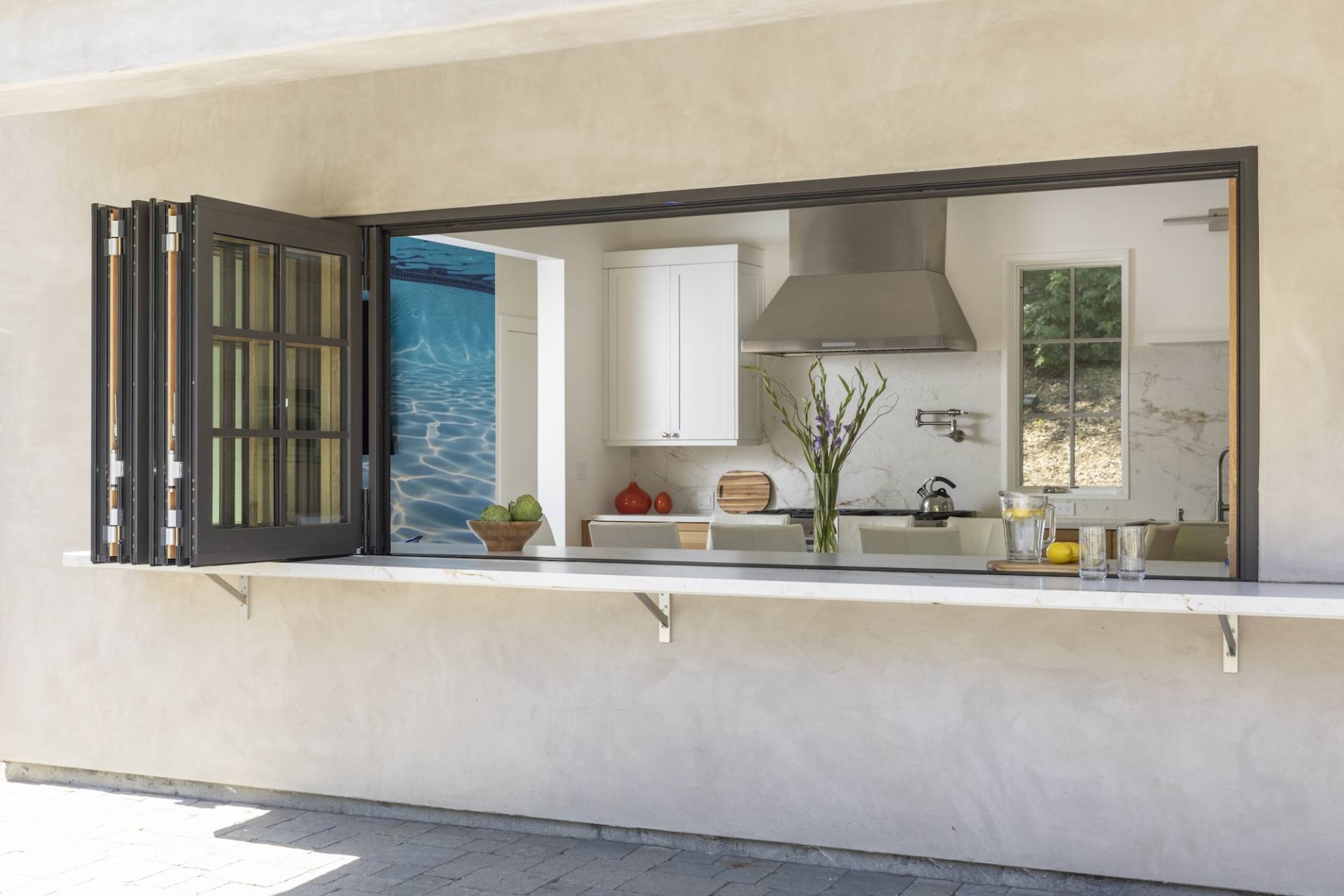 Lafayette, CA Pool House and ADU designed and built by Canyon Design Build. Featuring strong indoor/outdoor connection with master suite, fully equipped kitchen, outdoor shower, and renovated pool area. 