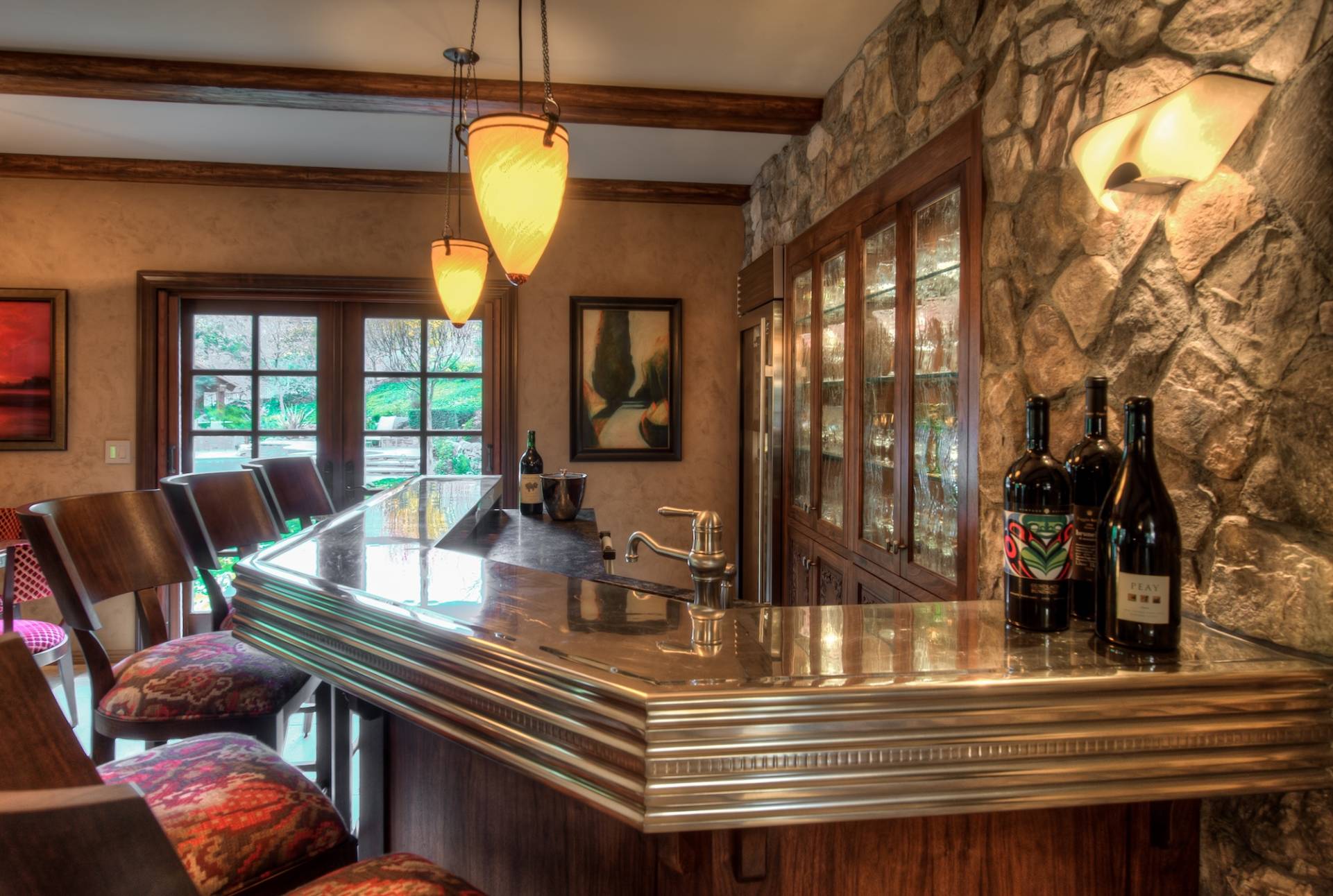 Custom built-in glass display and custom bar countertop in at-home bar by Canyon Design Build in Danville, CA home remodel.