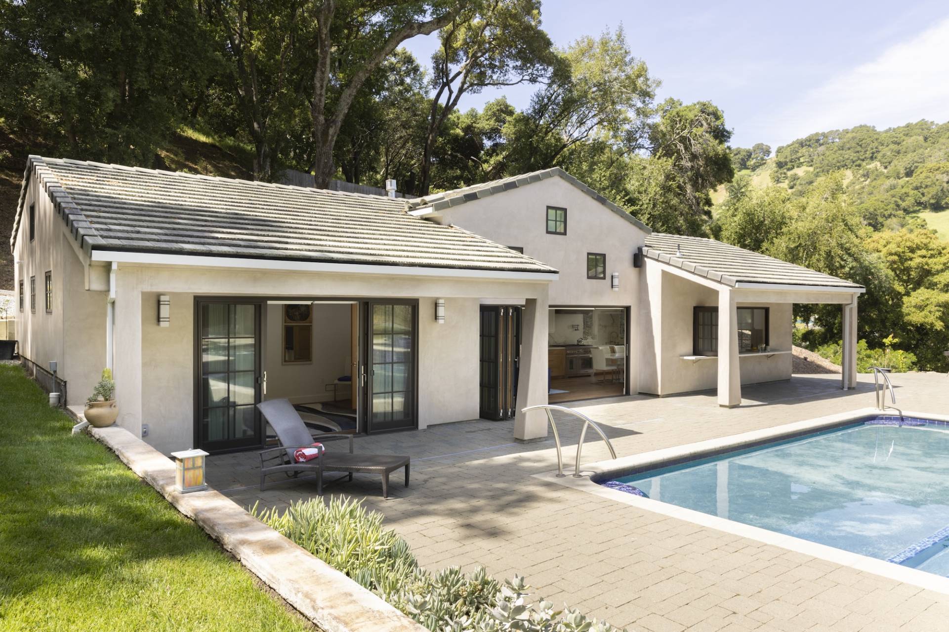Lafayette, CA Pool House and ADU designed and built by Canyon Design Build. Featuring strong indoor/outdoor connection with master suite, fully equipped kitchen, outdoor shower, and renovated pool area. 