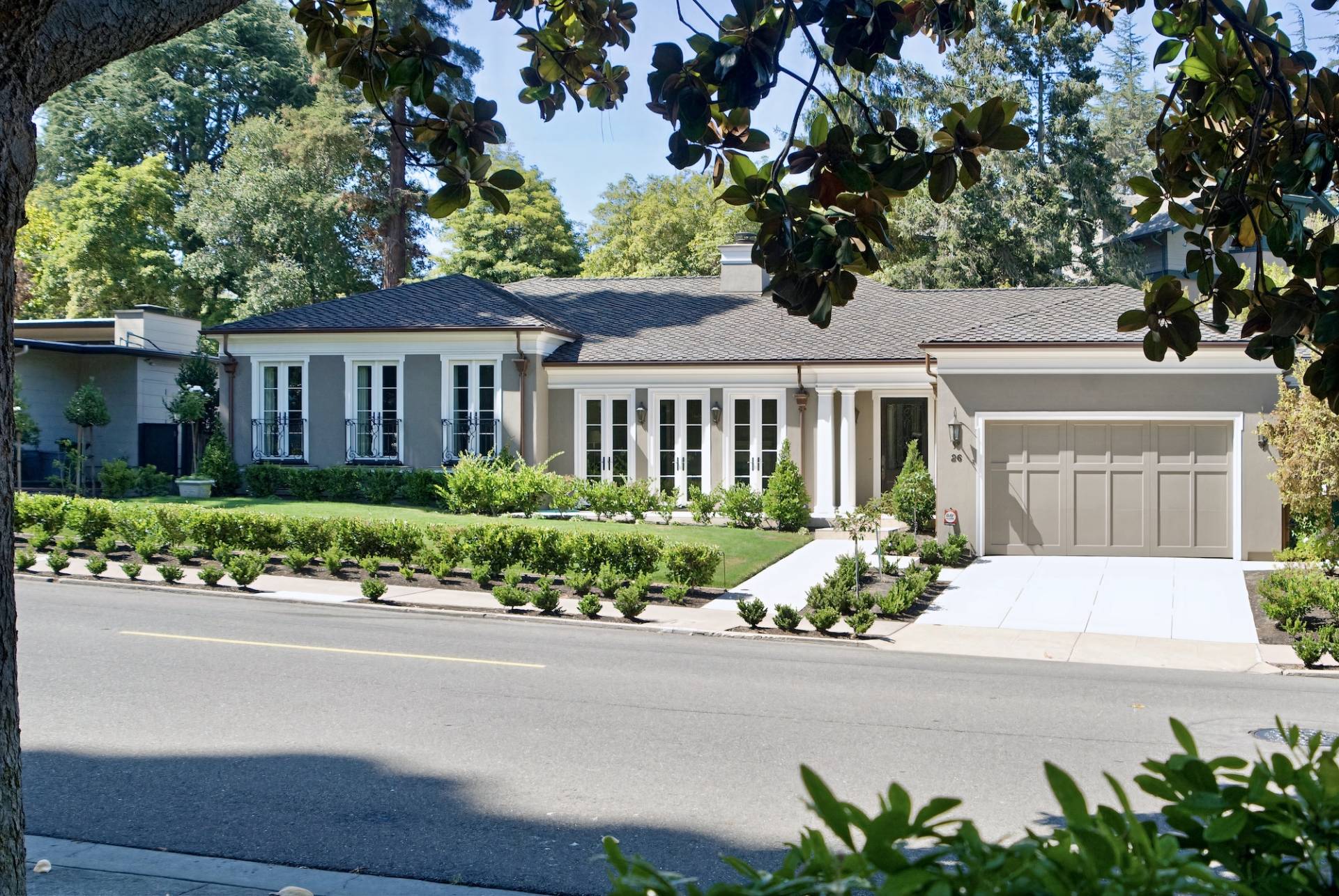 Full-home remodel by Canyon Design Build in Piedmont, CA blends classic French-inspired kitchen design with modern function, indoor-outdoor flow, and refined curb appeal across updated living spaces.